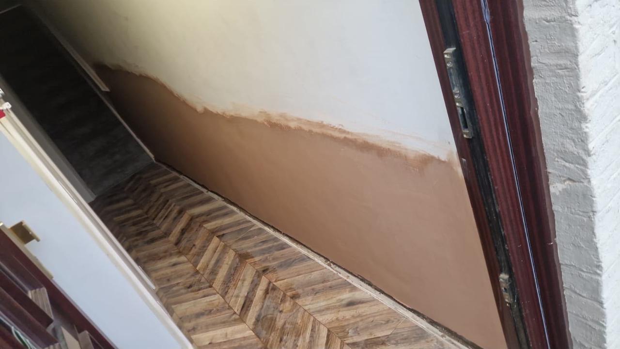 Damp proof plastering completed to a hallway wall