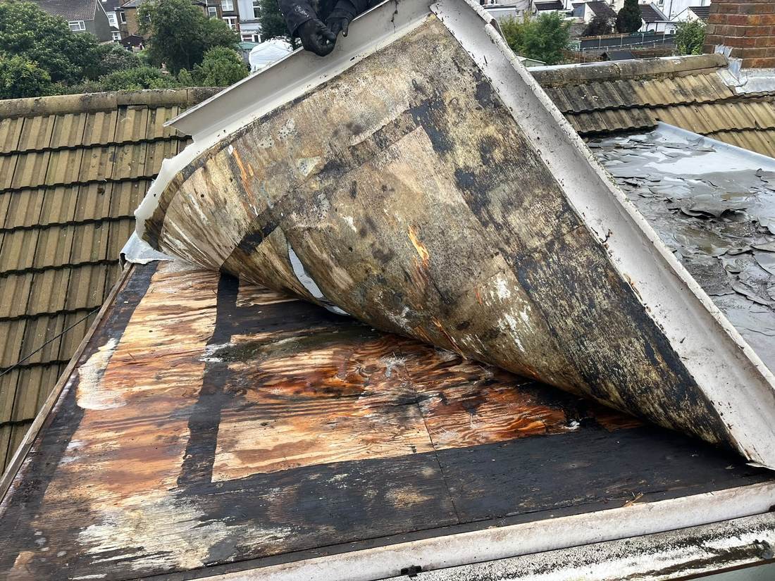 Rotten roof deck exposed after stripping felt